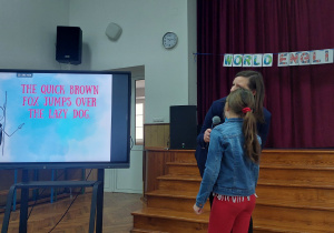 uczniowie i nauczyciel patrzą na ekran monitora