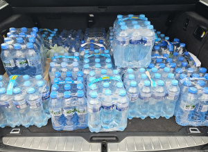 Zgrzewki wody półlitrowej w bagażniku auta.